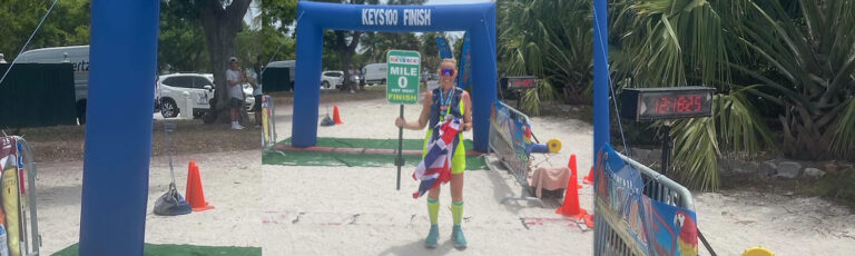 woman under finishing line on beach