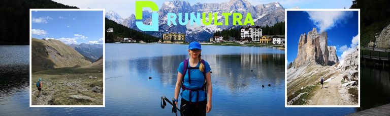 Emma Harrison standing in front of a lake with mountains in the distance behind her
