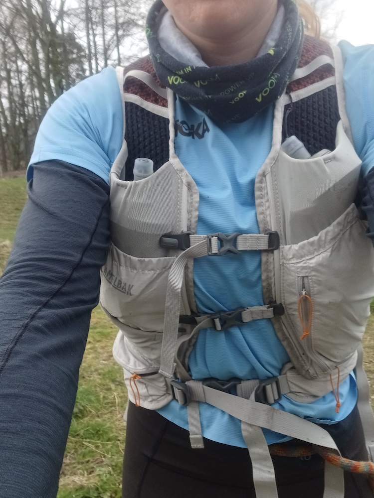 A photo of Loz wearing the Camelbak Octane 22l from the front, looking at the clasps and pockets it has