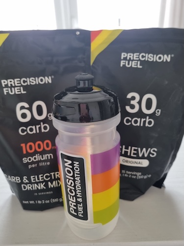 two packets of Precision Fuel behind a Precision Fuel & Hydration bottle