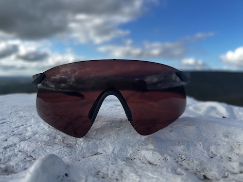 Rudy Project Astral Sphere sunglasses on snow, with photochromic lenses darkened by bright mountain light.