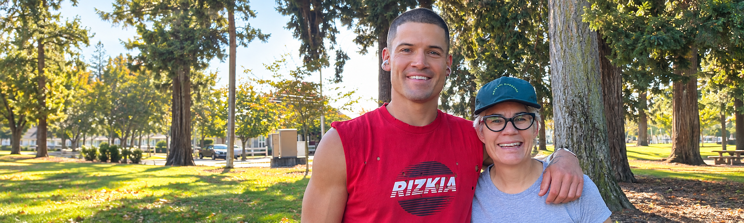 The author smiles beside runner William Goodge outdoors after their community run in Vancouver, Washington.